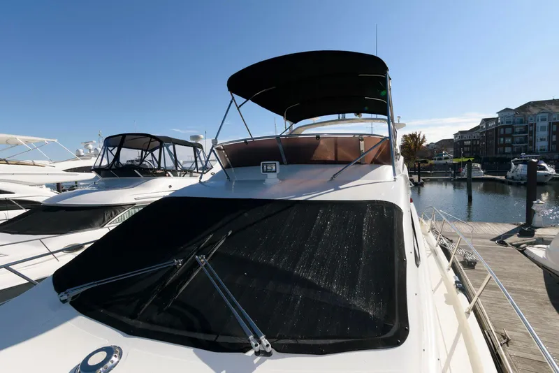 Slide: The Image of 2005 Azimut 50 Flybridge yacht docked at marina under clear blue sky. - 17