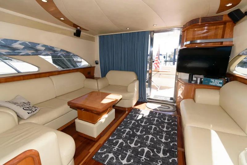 Slide: The Image of Luxurious interior of 2005 Azimut 50 Flybridge yacht with cream leather seating and nautical decor. - 21