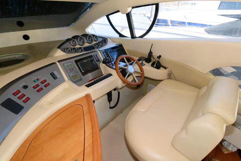 Slide: The Image of 2005 Azimut 50 Flybridge helm with leather seating and modern controls. - 23