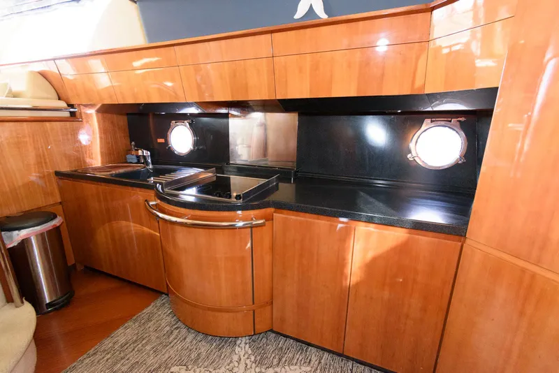 Slide: The Image of Luxurious kitchen interior of 2005 Azimut 50 Flybridge yacht with wood cabinetry. - 26