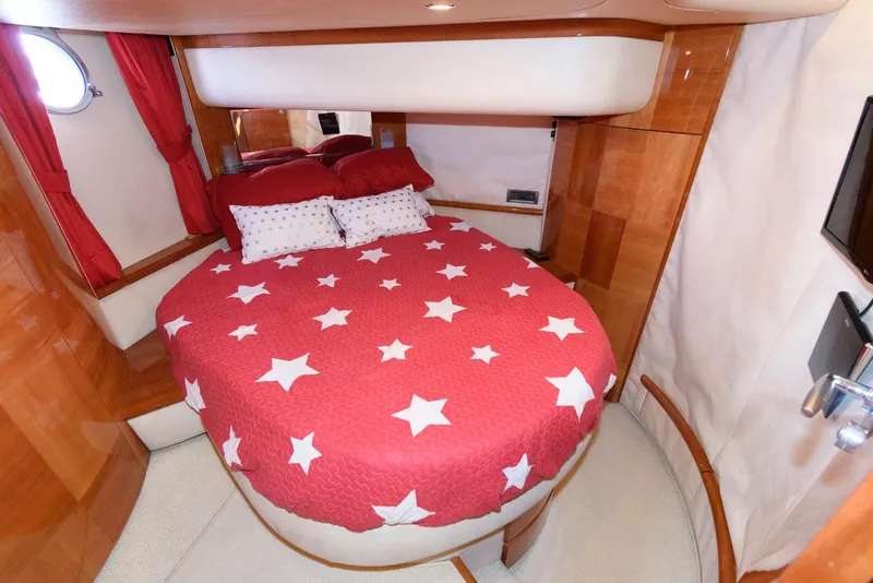 Slide: The Image of Luxurious bedroom in 2005 Azimut 50 Flybridge yacht with star-patterned bedding. - 28