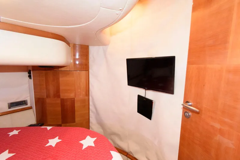 Slide: The Image of Interior of 2005 Azimut 50 Flybridge yacht with TV and star-patterned bedding. - 29
