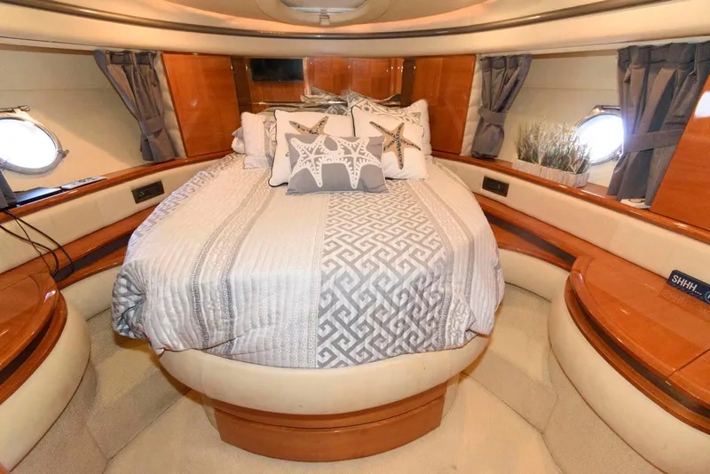 Slide: The Image of Luxurious 2005 Azimut 50 Flybridge yacht bedroom with elegant bedding and wood accents. - 31
