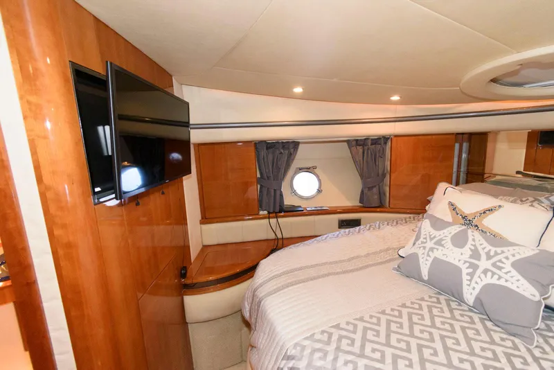 Slide: The Image of Luxurious 2005 Azimut 50 Flybridge yacht bedroom with TV and elegant decor. - 32