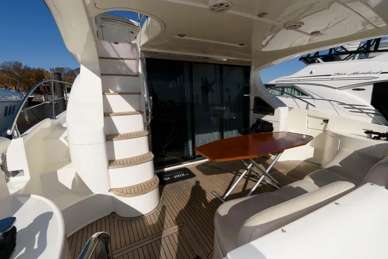 Slide: The Image of 2005 Azimut 50 Flybridge yacht with spacious deck and elegant seating area. - 4