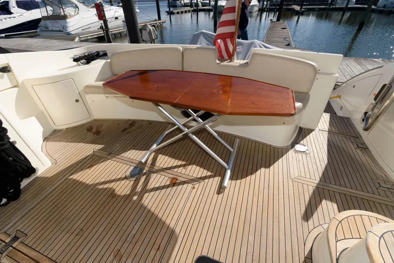 Slide: The Image of Azimut 50 Flybridge 2005 yacht deck with wooden table and seating area. - 5