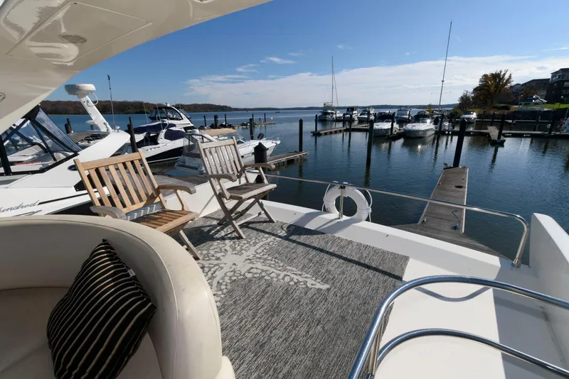 Slide: The Image of Azimut 50 Flybridge 2005 yacht deck with chairs overlooking marina. - 8