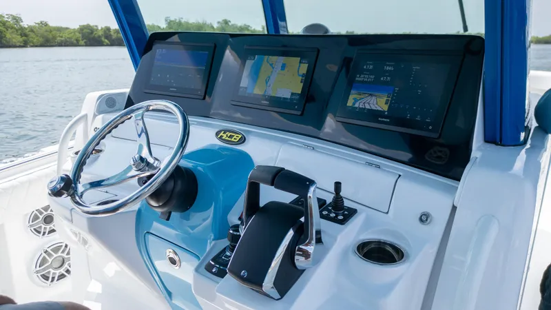 Slide: The Image of 2025 HCB 39 Speciale boat dashboard with advanced navigation screens and controls. - 13