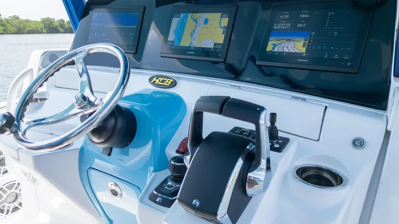 Slide: The Image of 2025 HCB 39 Speciale boat dashboard with steering wheel and navigation screens. - 6