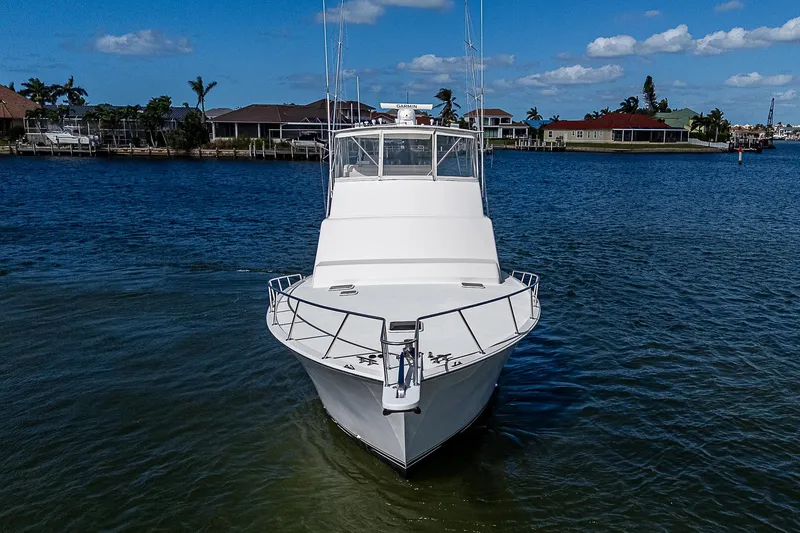 Slide: The Image of 1999 Post 50 Convertible yacht on calm water, clear sky background. - 12