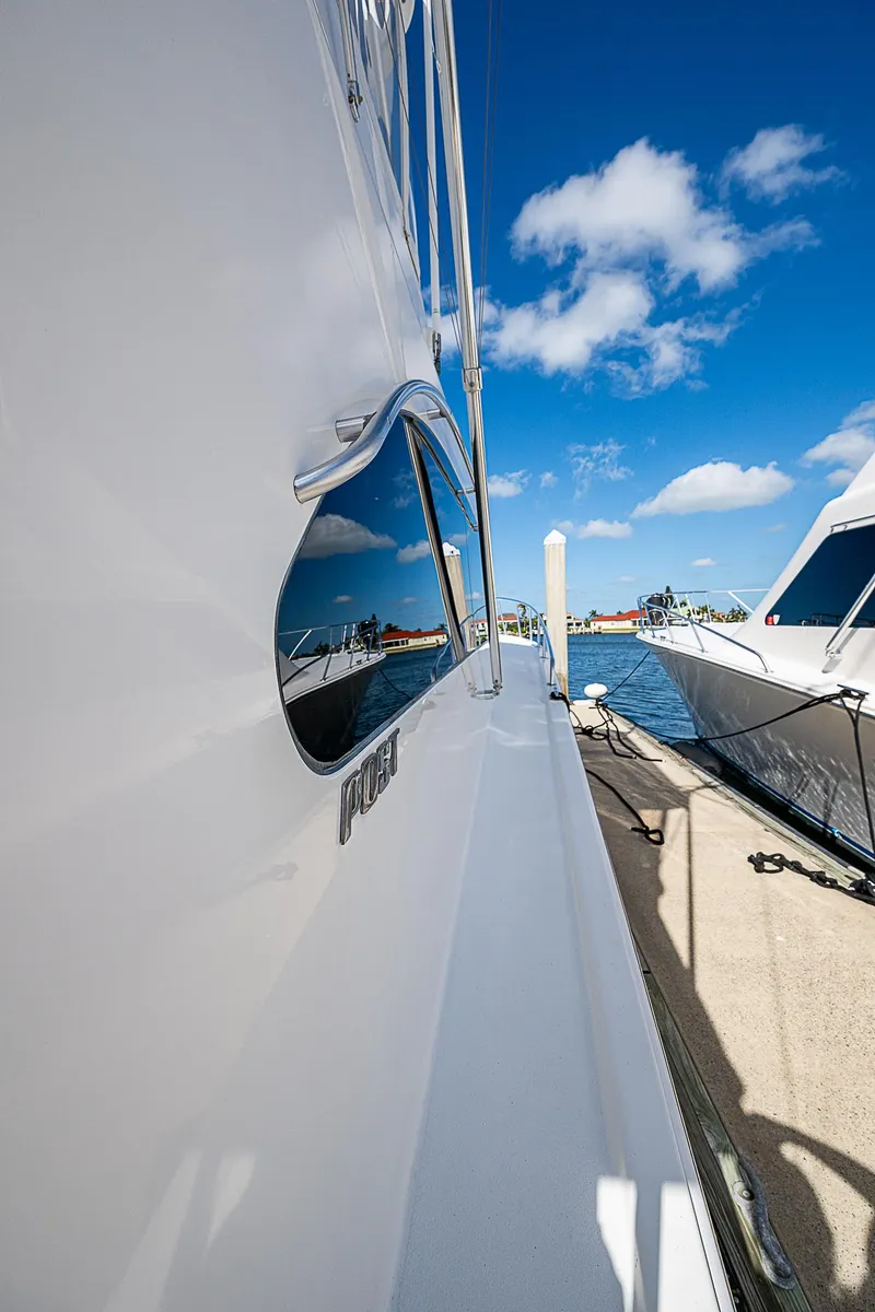 Slide: The Image of 1999 Post 50 Convertible yacht docked under a clear blue sky. - 13
