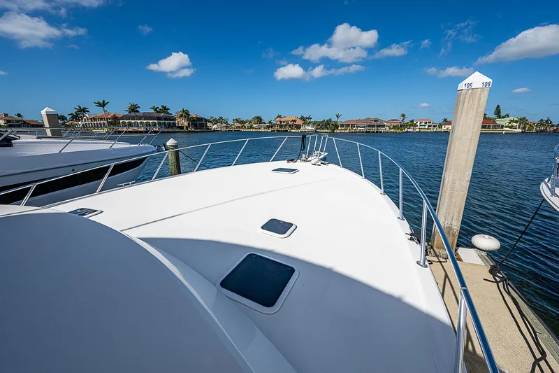 Slide: The Image of 1999 Post 50 Convertible yacht docked at marina under clear blue sky. - 14