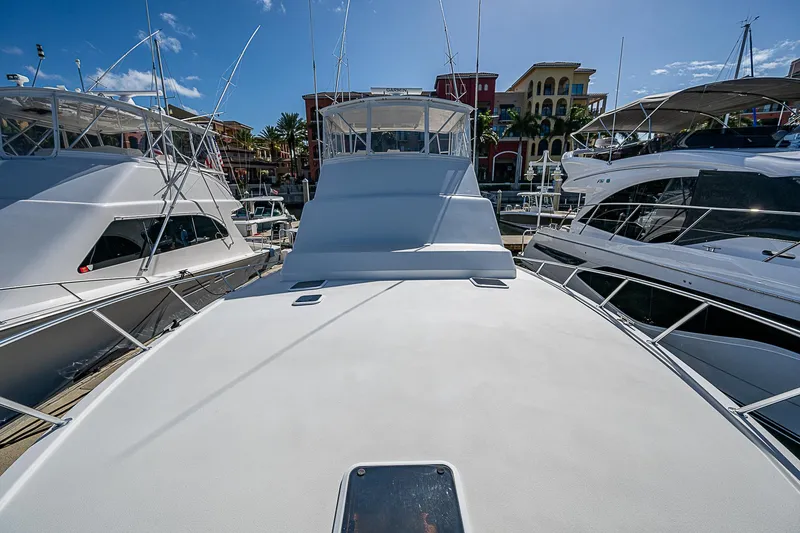 Slide: The Image of 1999 Post 50 Convertible yacht docked in marina under clear blue sky. - 16