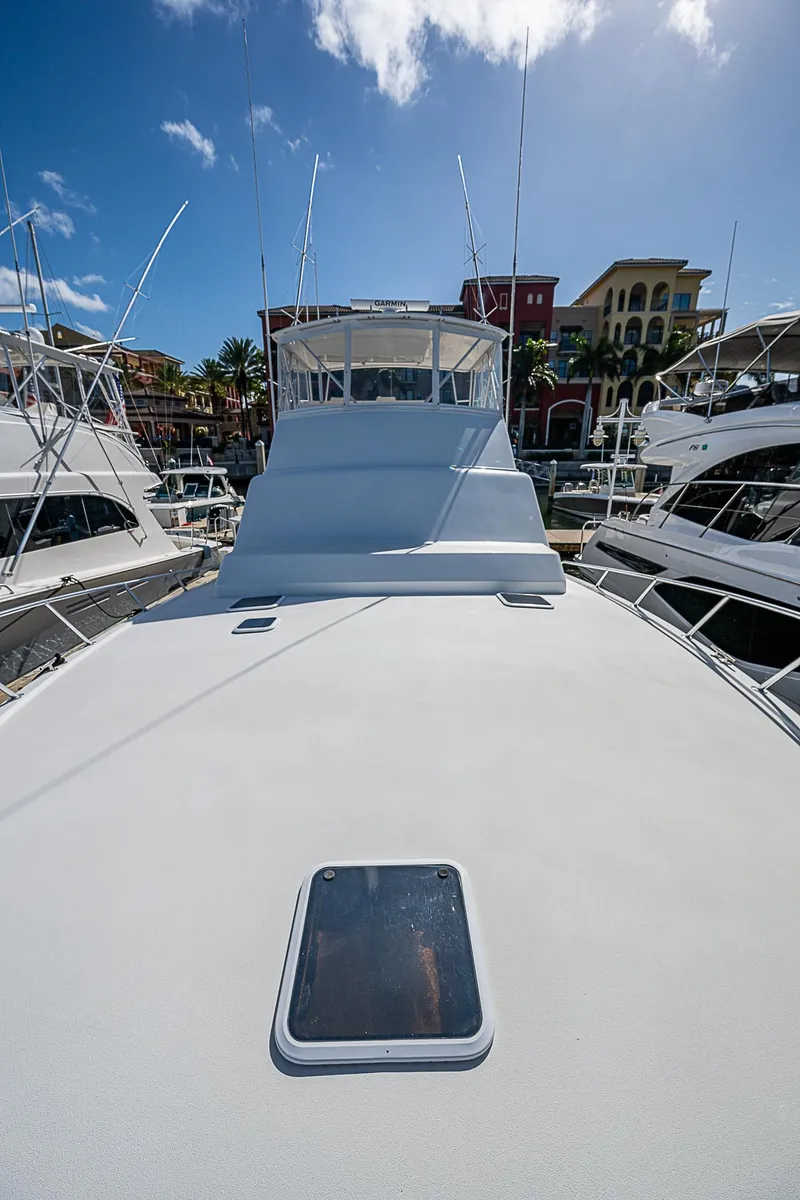 Slide: The Image of 1999 Post 50 Convertible yacht docked in a sunny marina. - 17