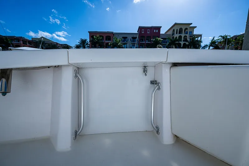 Slide: The Image of 1999 Post 50 Convertible boat deck with railing, buildings in background. - 20