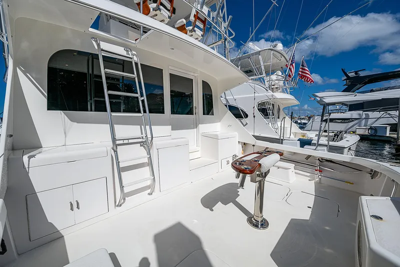 Slide: The Image of 1999 Post 50 Convertible yacht deck with fishing chair and ladder, docked at marina. - 23
