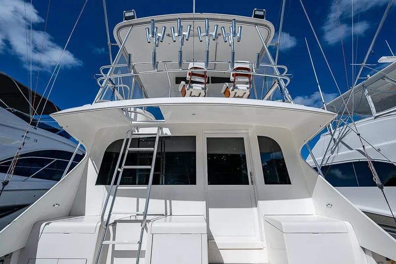 Slide: The Image of 1999 Post 50 Convertible yacht, rear view with ladder and upper deck, under blue sky. - 27