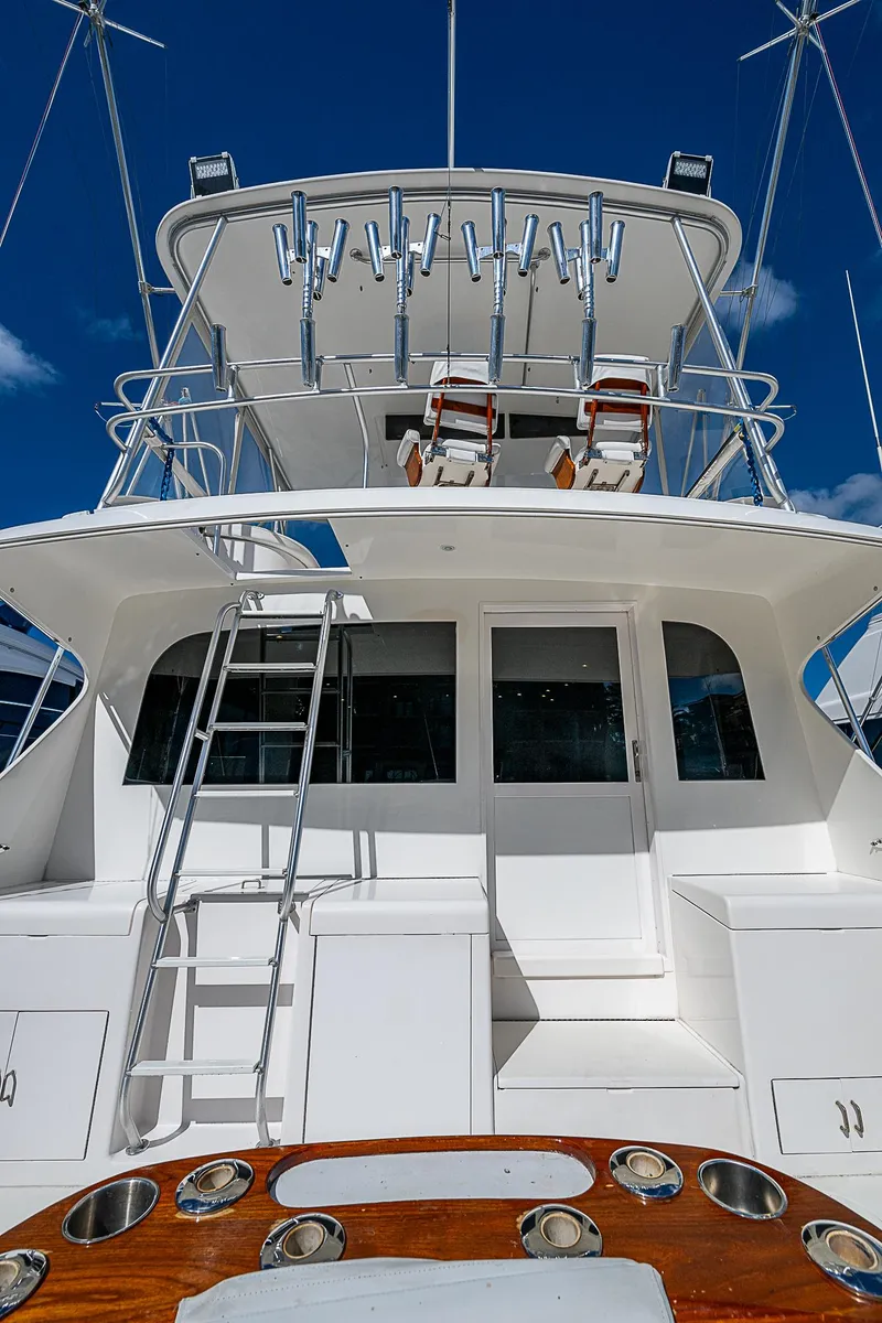 Slide: The Image of 1999 Post 50 Convertible yacht with fishing rods and ladder under clear blue sky. - 28