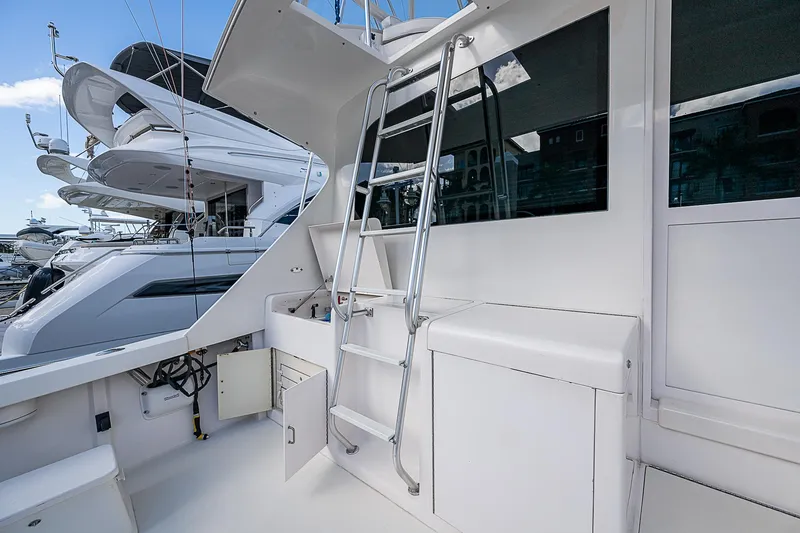 Slide: The Image of 1999 Post 50 Convertible yacht with ladder and sleek white exterior. - 29