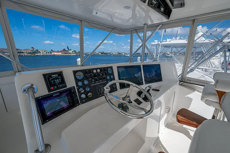 Slide: The Image of Interior of a 1999 Post 50 Convertible yacht with steering wheel and navigation instruments. - 33