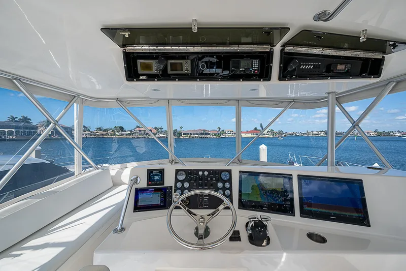 Slide: The Image of 1999 Post 50 Convertible yacht cockpit with steering wheel and navigation screens. - 34
