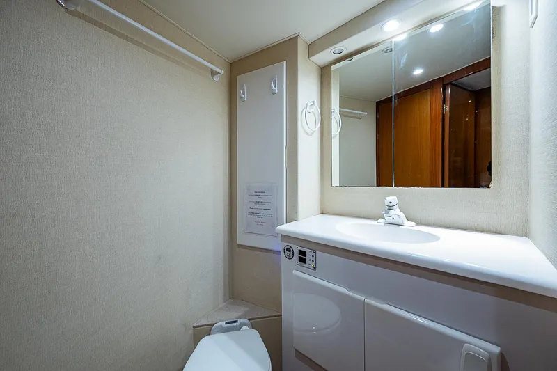 Slide: The Image of 1999 Post 50 Convertible yacht bathroom with modern fixtures and mirror. - 40