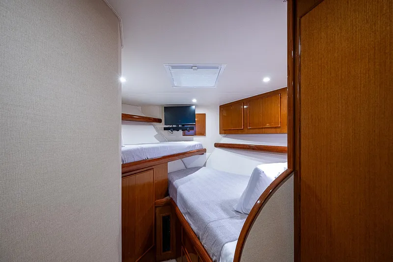 Slide: The Image of Interior of 1999 Post 50 Convertible yacht with cozy twin beds and wooden cabinetry. - 43