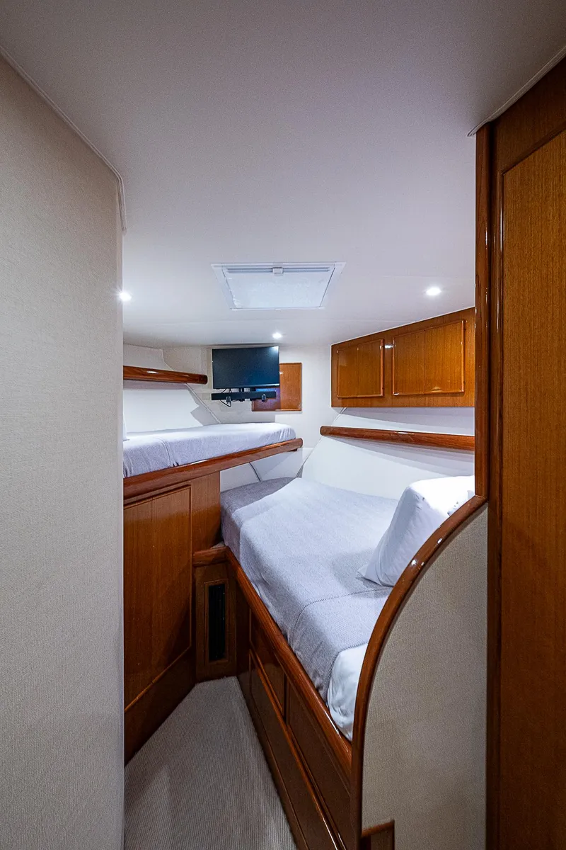 Slide: The Image of 1999 Post 50 Convertible yacht interior with cozy twin beds and wooden cabinetry. - 44