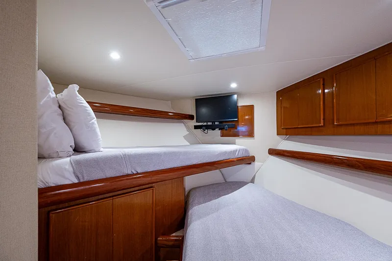 Slide: The Image of Cozy cabin interior of 1999 Post 50 Convertible yacht with twin beds and TV. - 45