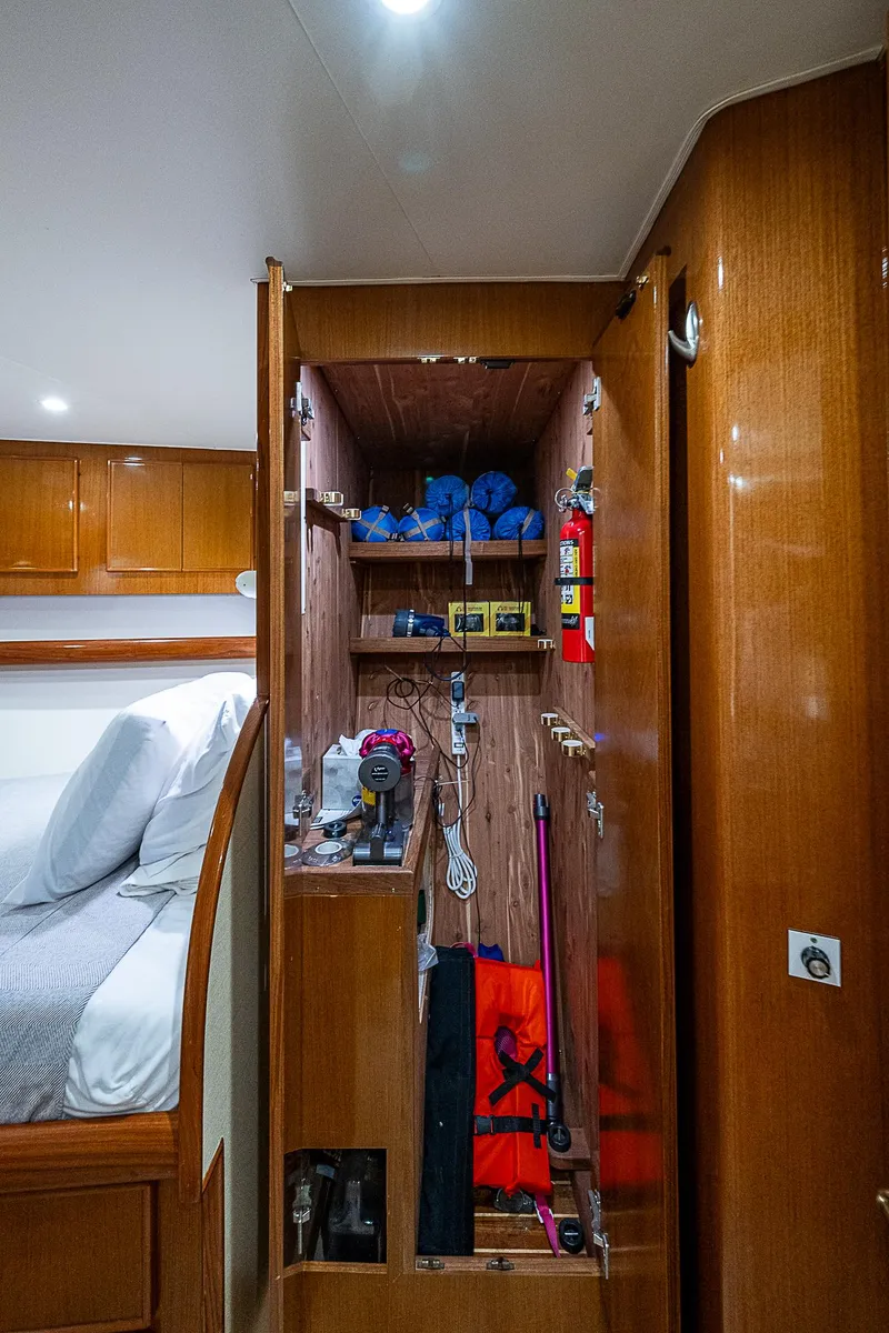 Slide: The Image of 1999 Post 50 Convertible yacht interior with open storage cabinet. - 48