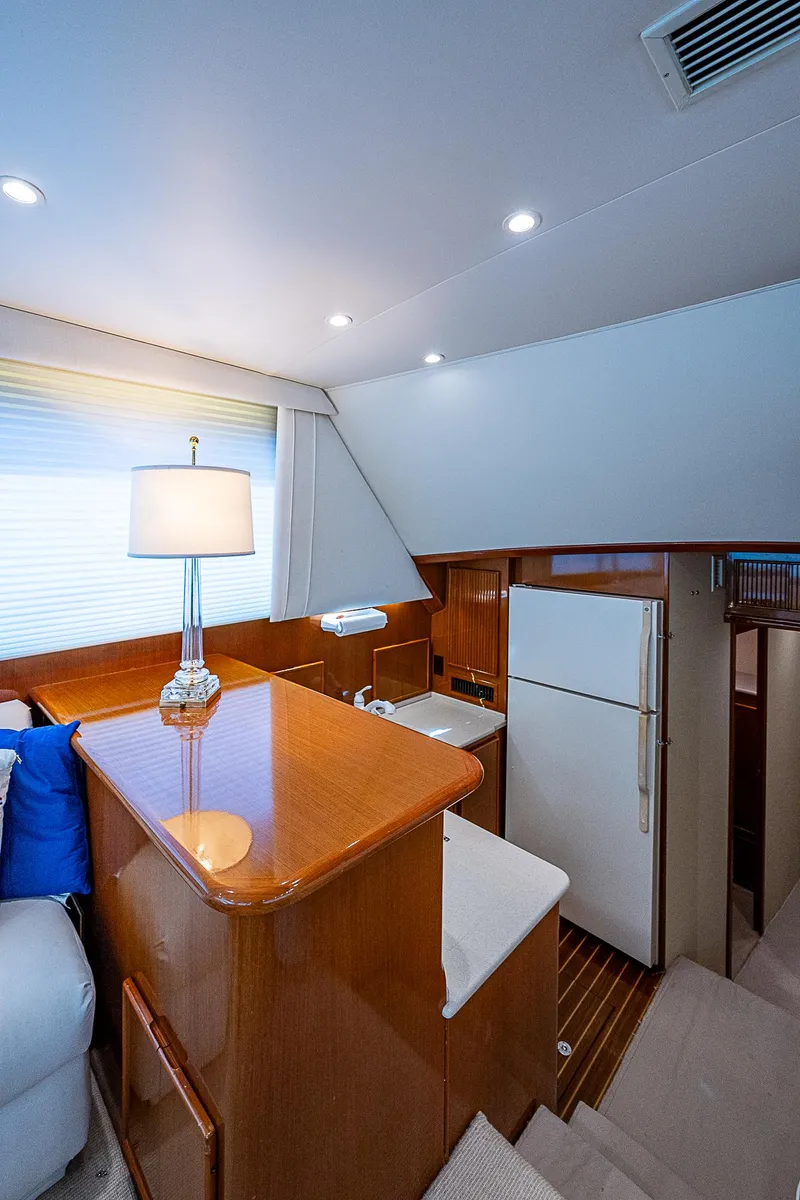 Slide: The Image of Interior of a 1999 Post 50 Convertible yacht with kitchen and seating area. - 49