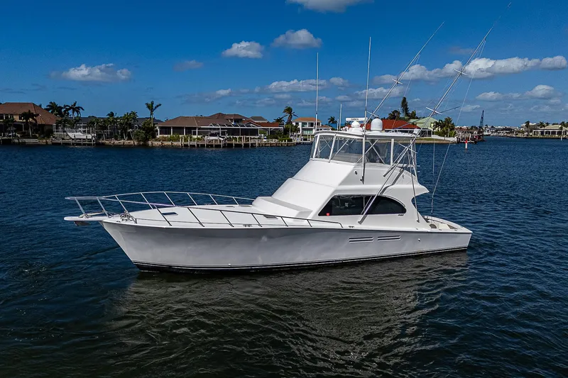 Slide: The Image of 1999 Post 50 Convertible yacht on calm water under blue sky. - 5
