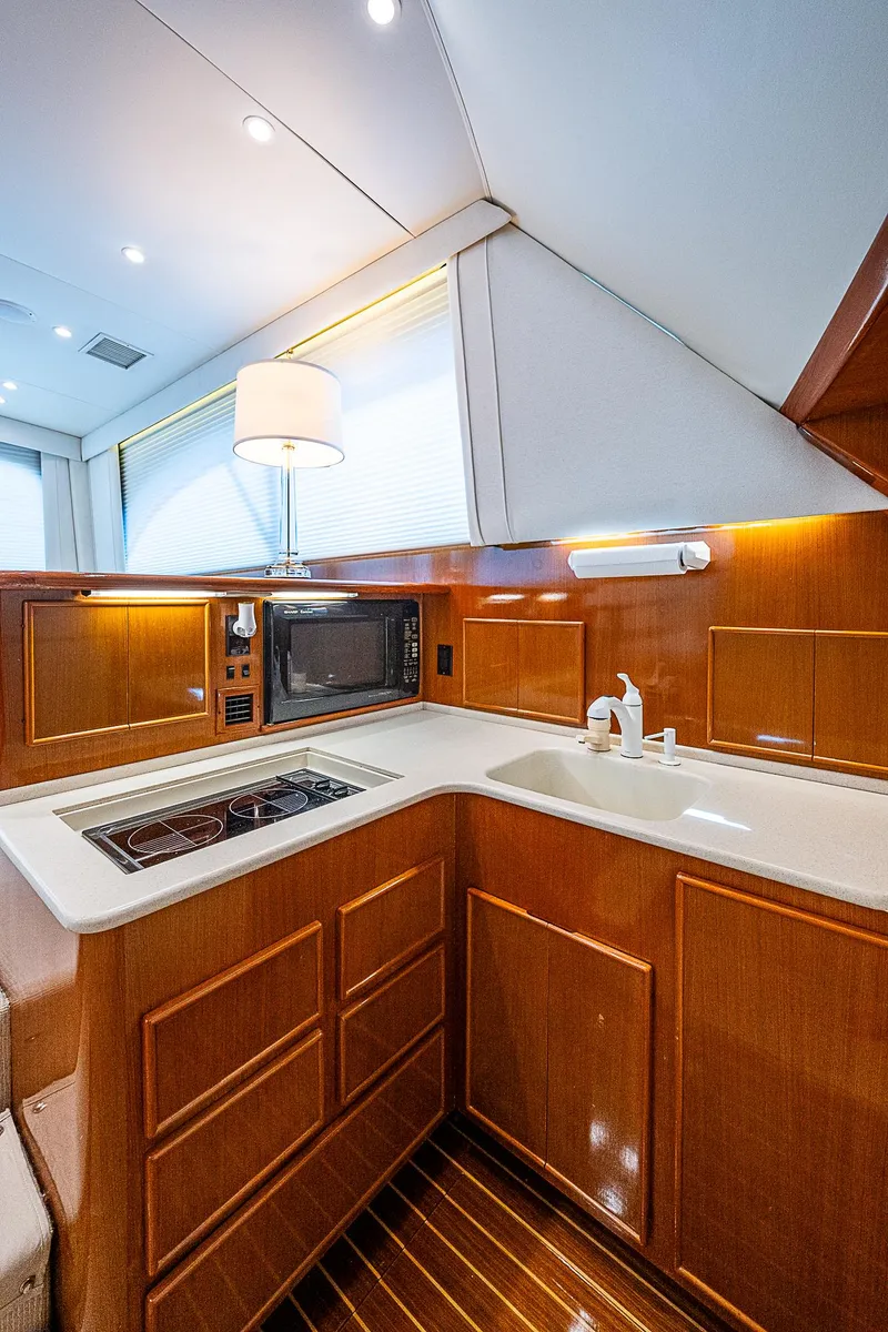 Slide: The Image of Luxurious 1999 Post 50 Convertible yacht kitchen with modern amenities and wood cabinetry. - 51