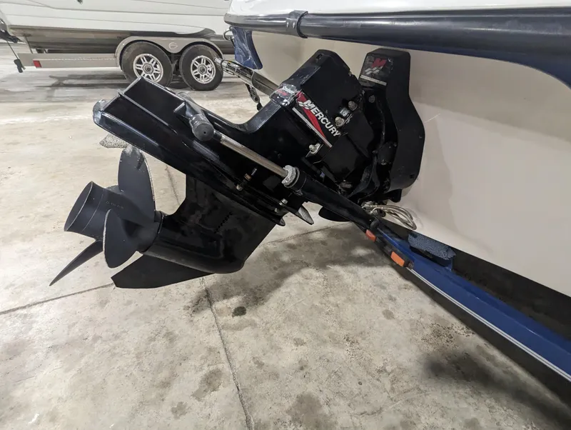 Slide: The Image of 2003 Crownline 180 BR boat with Mercury outboard motor in a garage. - 4