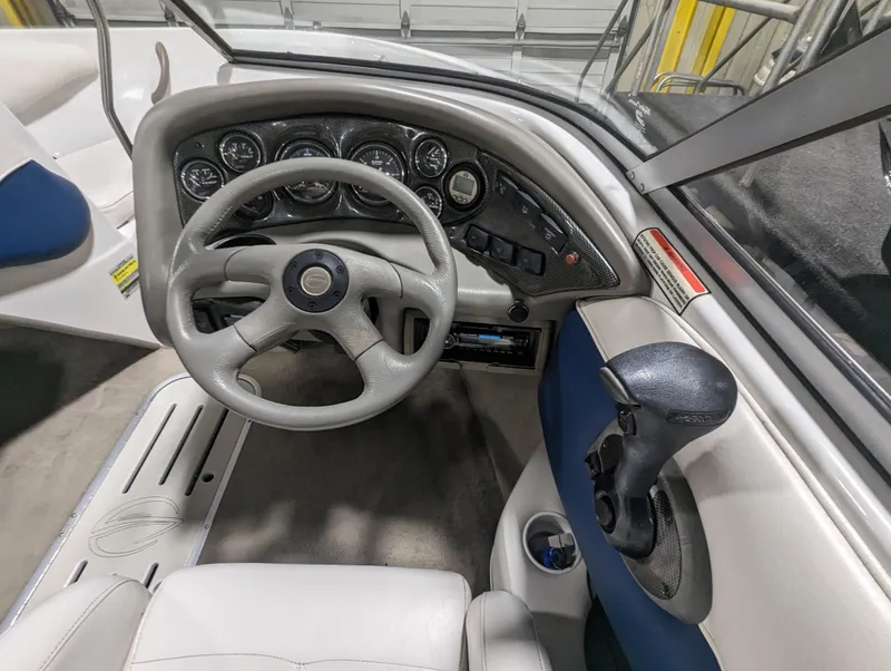 Slide: The Image of 2003 Crownline 180 BR boat dashboard with steering wheel and controls. - 6