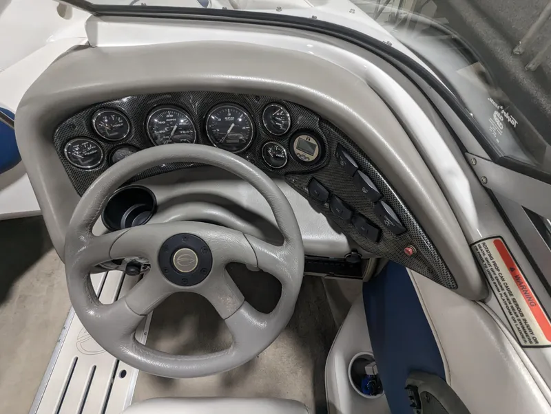 Slide: The Image of 2003 Crownline 180 BR boat dashboard with steering wheel and instrument panel. - 7