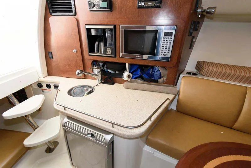 Slide: The Image of 2008 Hydra-Sports Vector 3500 VX cabin with kitchenette, microwave, and seating area. - 18