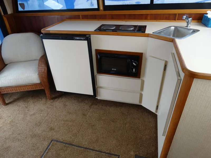 Slide: The Image of Interior of 1991 Egg Harbor 33 Sedan with kitchenette and seating area. - 13