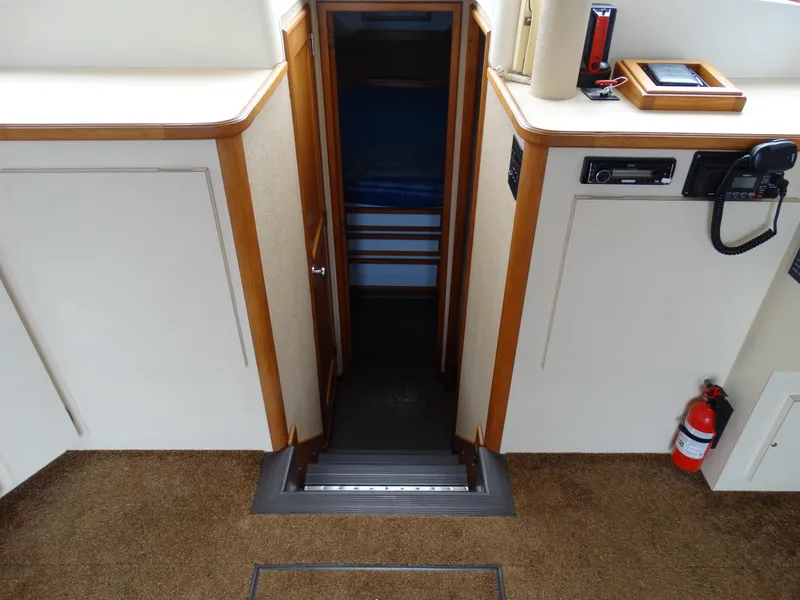 Slide: The Image of Interior of 1991 Egg Harbor 33 Sedan, featuring stairs and fire extinguisher. - 14
