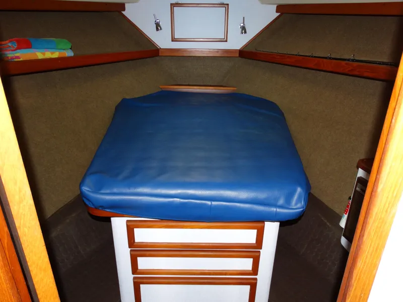 Slide: The Image of Interior of a 1991 Egg Harbor 33 Sedan yacht with blue mattress. - 15