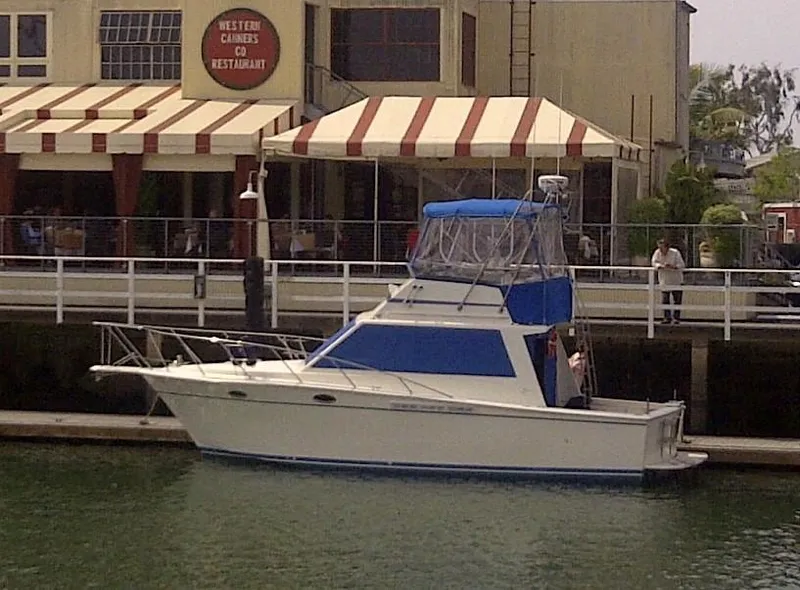 Slide: The Image of 1991 Egg Harbor 33 Sedan docked in front of a restaurant. - 3