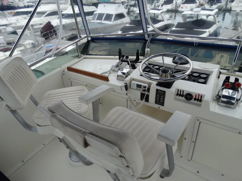 Slide: The Image of 1991 Egg Harbor 33 Sedan cockpit with steering and controls. - 38