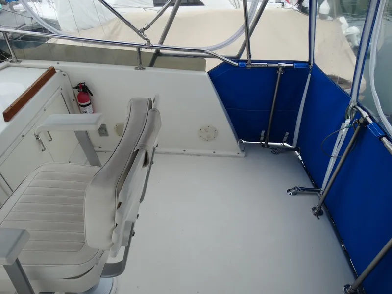 Slide: The Image of Interior of a 1991 Egg Harbor 33 Sedan boat with seat and fire extinguisher. - 39