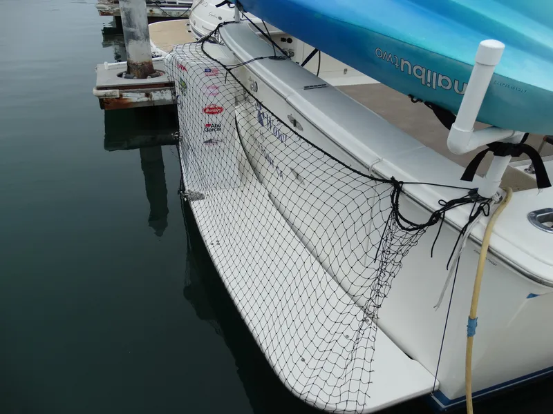 Slide: The Image of 1991 Egg Harbor 33 Sedan with netting at stern in harbor. - 6