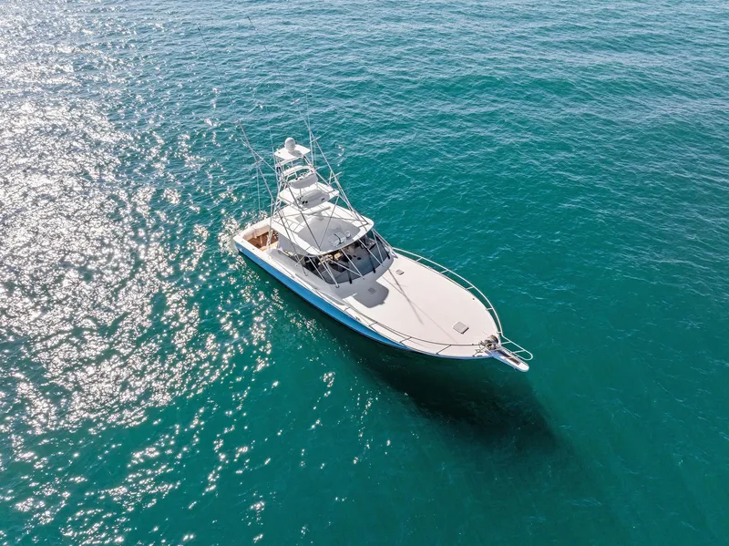 Slide: The Image of 2007 Viking 52 Open yacht cruising on clear blue water. - 15