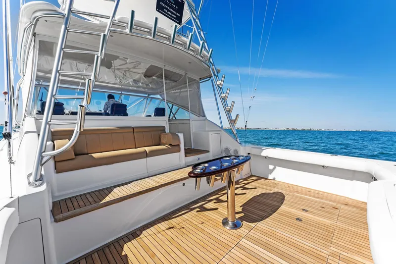 Slide: The Image of 2007 Viking 52 Open yacht with spacious deck and seating, cruising on a sunny day. - 18