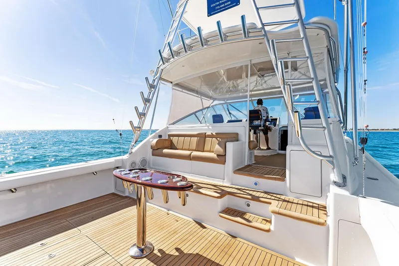 Slide: The Image of 2007 Viking 52 Open yacht with spacious deck and seating, cruising on clear blue waters. - 20