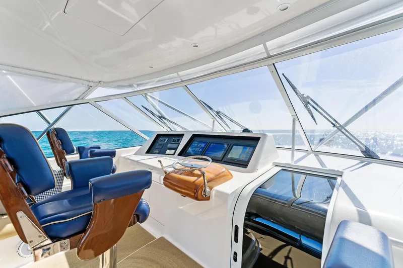 Slide: The Image of Interior of 2007 Viking 52 Open yacht with blue seating and navigation controls. - 29