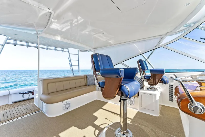 Slide: The Image of 2007 Viking 52 Open yacht interior with blue captain chairs and ocean view. - 34