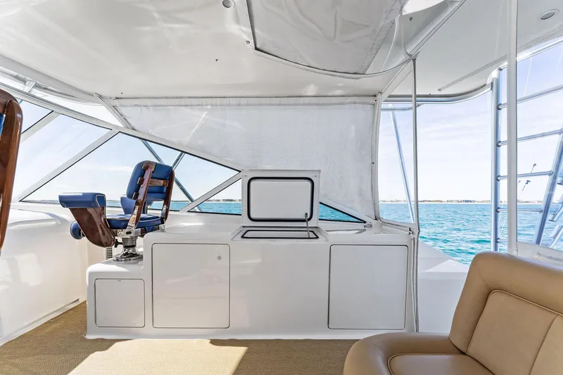 Slide: The Image of 2007 Viking 52 Open yacht interior with helm seat and ocean view. - 36